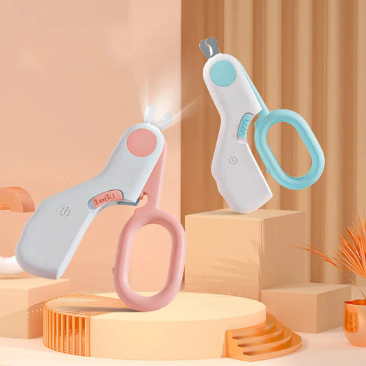 White, pink and blue Purrfect Pet Kingdom LED pet clippers with plastic scissor handles, safety guard and steel blades.