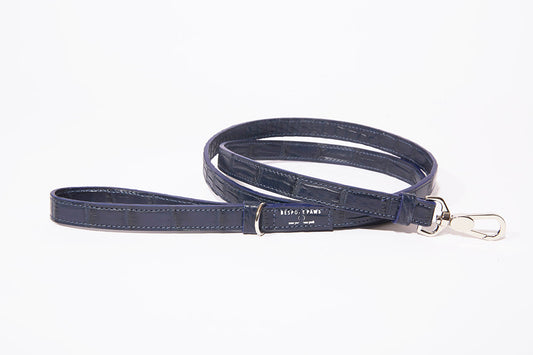 Navy blue alligator leather BESPOKE PAWS dog leash featuring silver hardware, a swivel clasp, and brand tag.