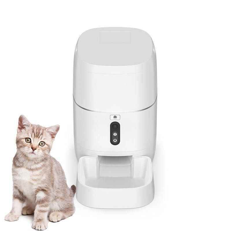 White automatic pet food dispenser by Purrfect Pet Kingdom with a cat sitting beside it