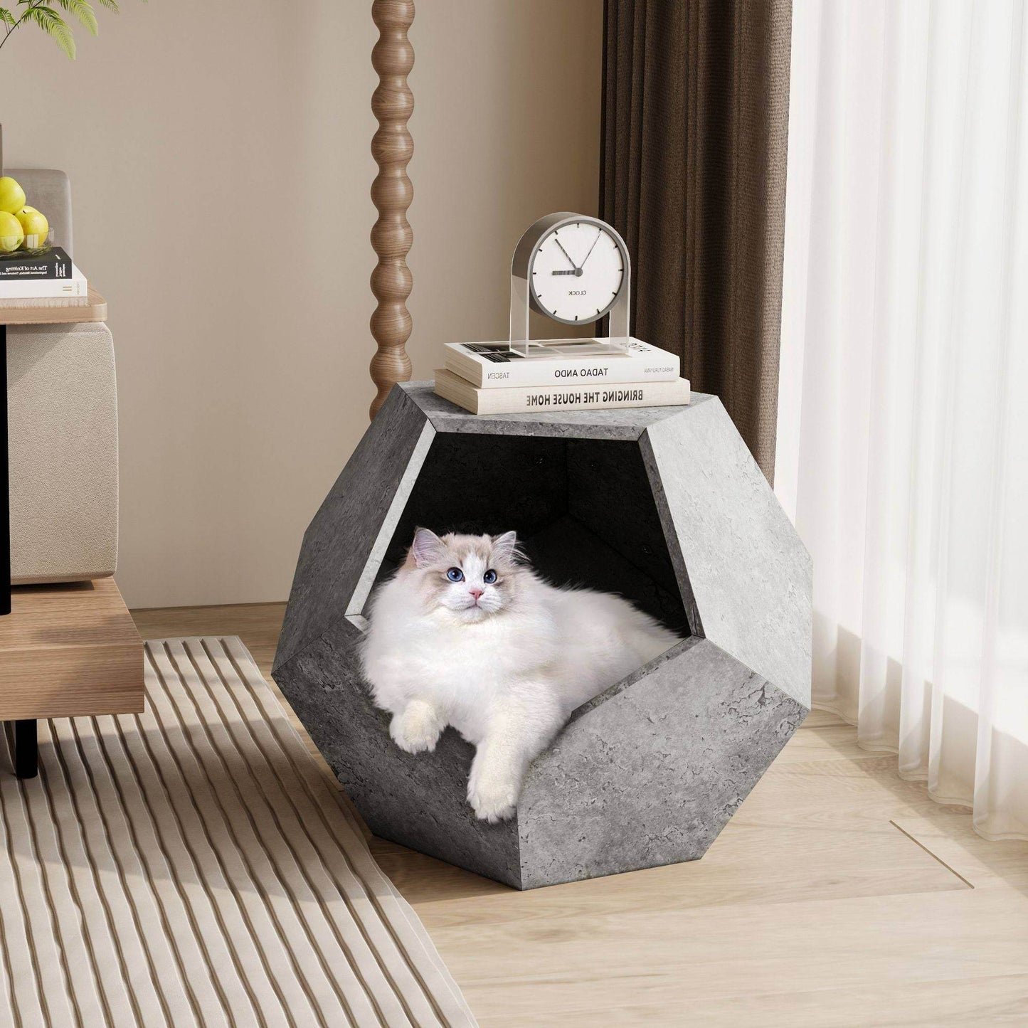 Cozy gray geometric cat bed from Purrfect Pet Kingdom with a fluffy white cat resting inside, perfect cat furniture for living room