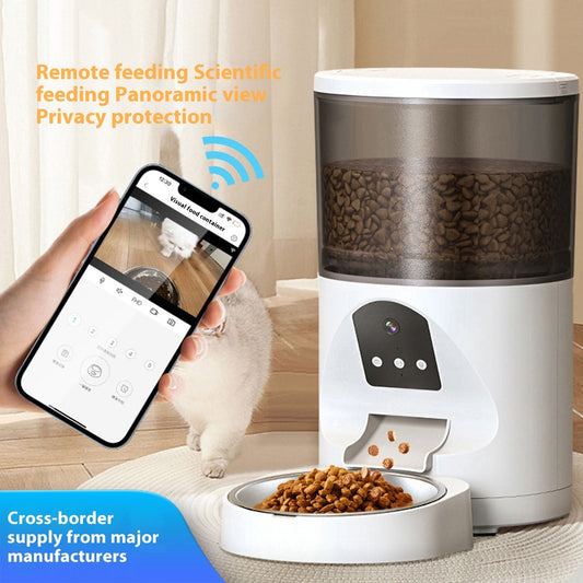 White and grey smart pet feeder with a camera, filling a metal bowl with dry kibble, controlled via a mobile app.