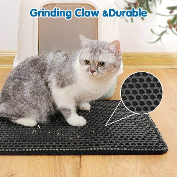 Grey and white cat sitting on a black Purrfect Pet Kingdom cat litter scatter control mat with textured surface