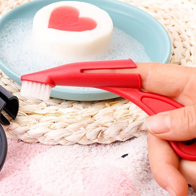 Red pet toothbrush being held next to heart-shaped soap bar on blue plate for pet dental care grooming supplies