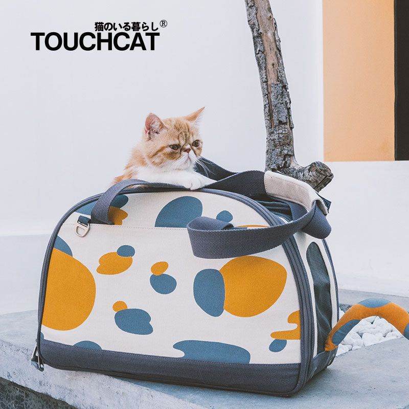 Stylish cat travel bag with orange and blue pattern featuring a cat resting on top by Purrfect Pet Kingdom