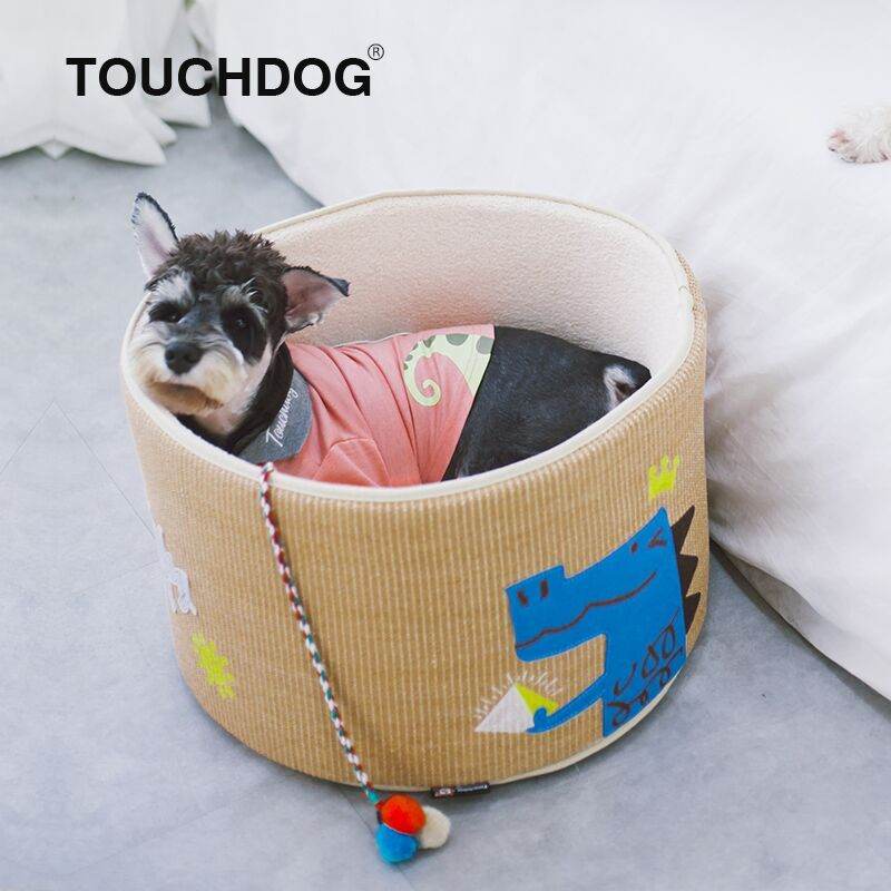 Cat scratcher and bed combo with colorful dragon design and attached toy ball on gray floor