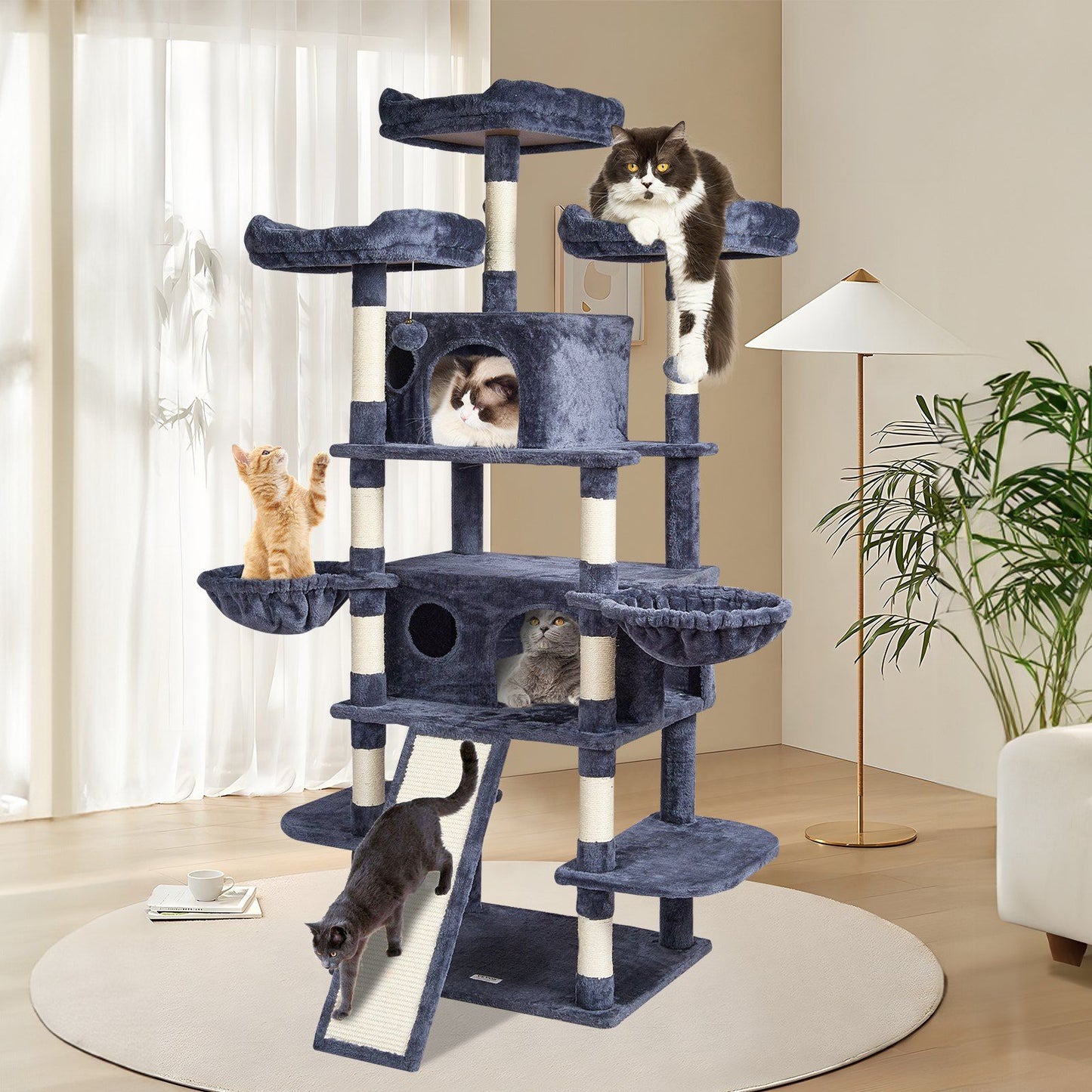 Purrfect Pet Kingdom cat tree with scratching posts in dark blue fabric hosting multiple cats in living room