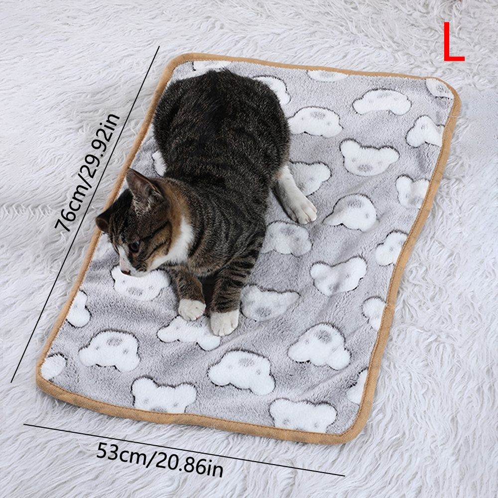 Cozy cat lying on Purrfect Pet Kingdom warming pet pad for cats and dogs with cloud pattern