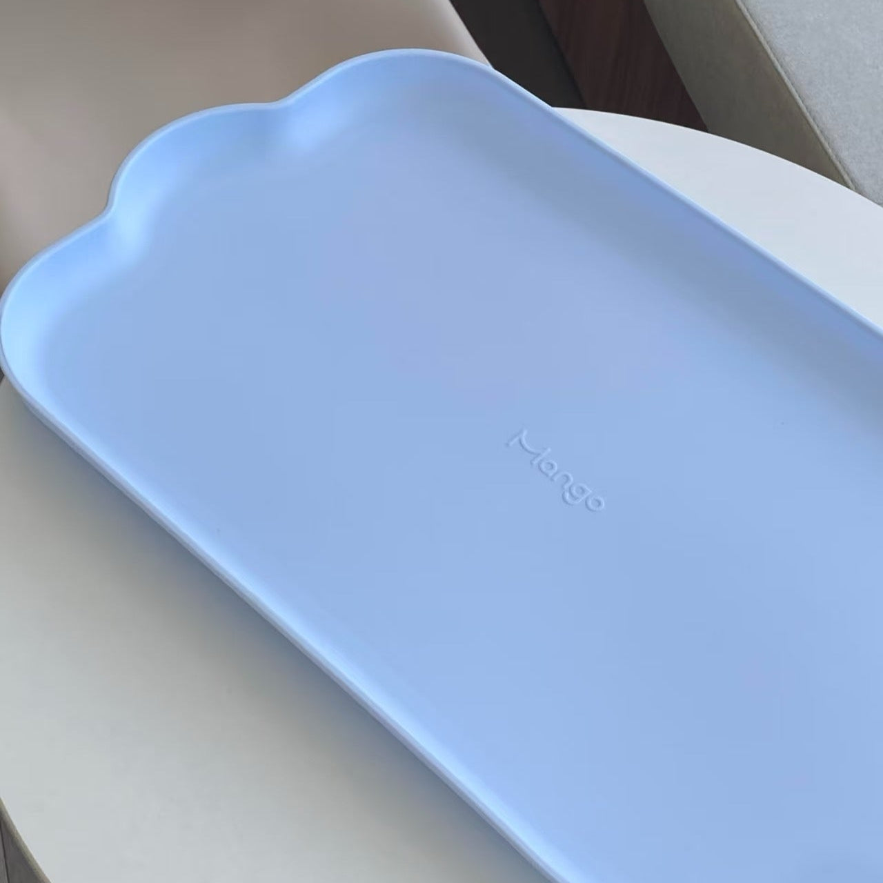 Light blue waterproof pet feeding mat from MangoPets designed to keep surfaces clean and dry