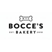 A happy dog waiting for a golden-baked treat in a cozy, sunlit kitchen with rustic, natural-ingredient accents.