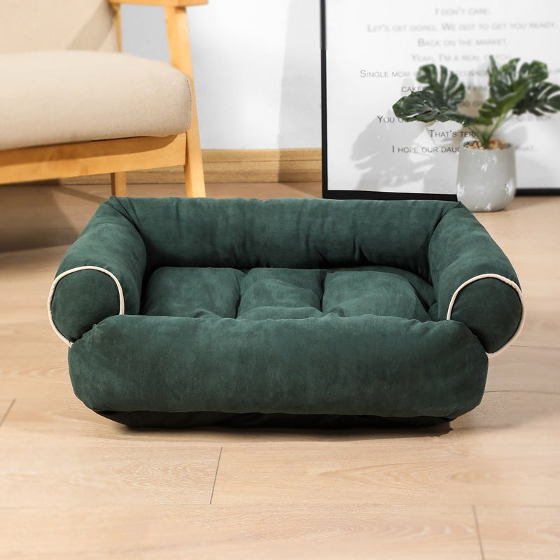 Estely forest green velvet pet sofa bed with padded bolsters and white piping trim.