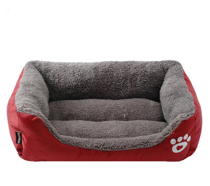 Estely red rectangular pet bed with grey fuzzy fleece interior, bolster sides, and a white paw heart logo.