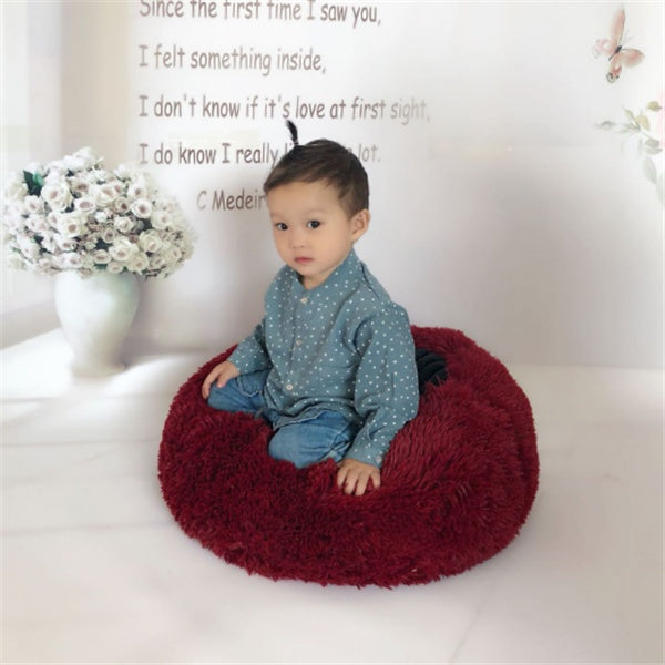 Estely burgundy round plush cat bed featuring cozy, shaggy deep red faux fur in a comfortable donut shape.