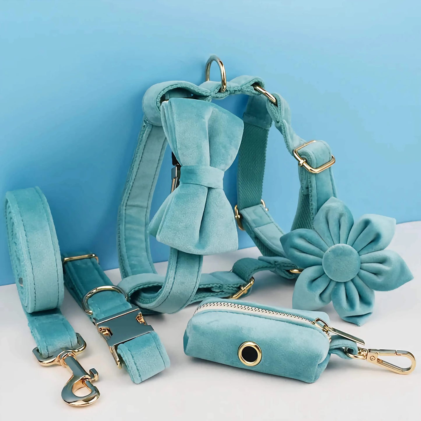 Purrfect Pet Kingdom turquoise velvet harness, leash, and collar set with gold hardware, bow, flower, and bag holder.
