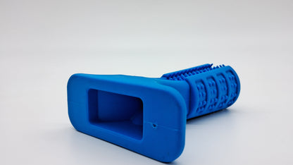 The Grinder by Toys N Treats Box: blue rubber dog toy with textured dental bristles and a flat base.