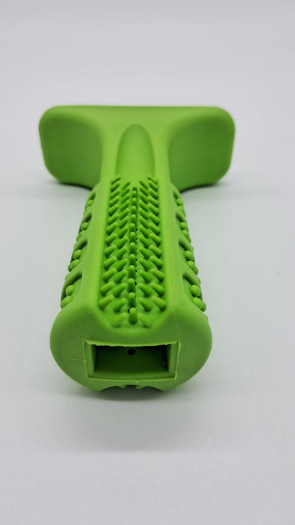 Lime green rubber T-shaped dog toy with textured dental bristles and a rectangular treat-dispensing opening.