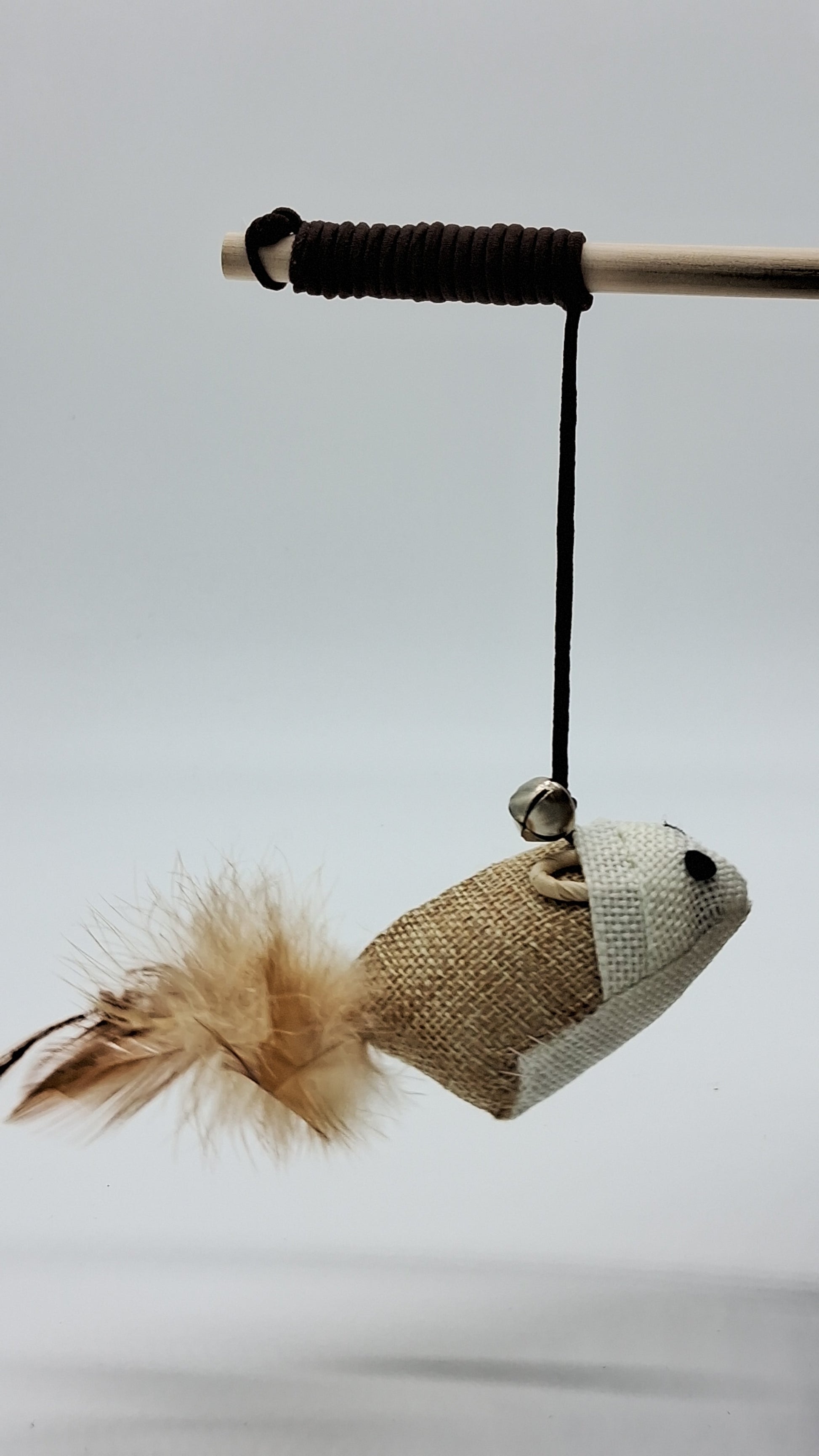 Toys N Treats Box wooden teaser wand with a burlap mouse toy, brown feathers, and a silver jingle bell.