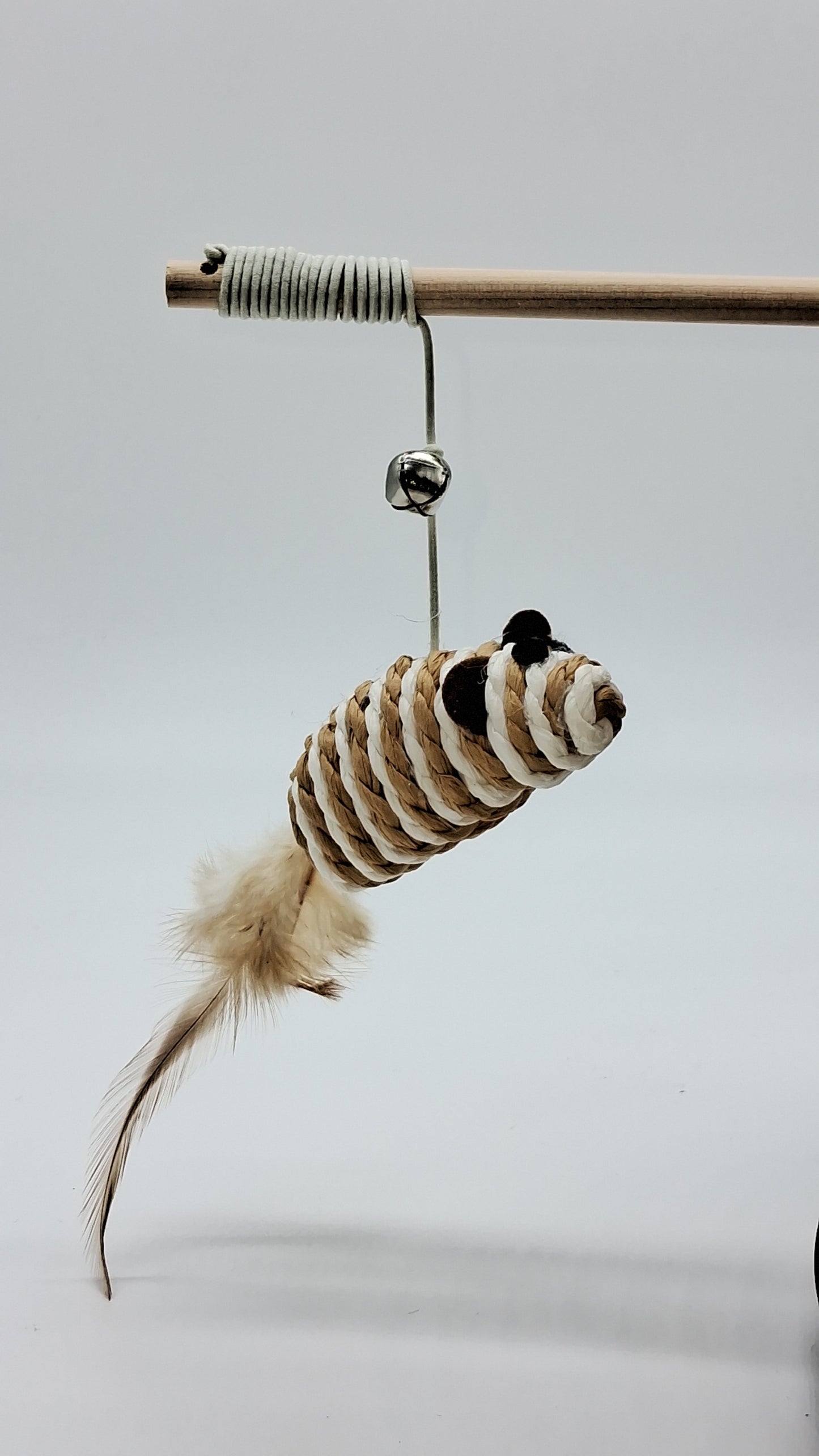 Toys N Treats Box wooden cat wand with a silver bell and woven brown and white rope mouse with feather tail.
