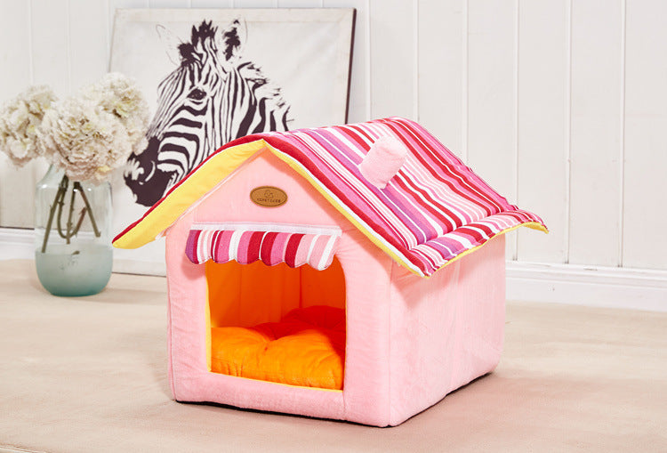 Estely pink plush dog house bed with red striped roof, orange cushion, and striped awning.