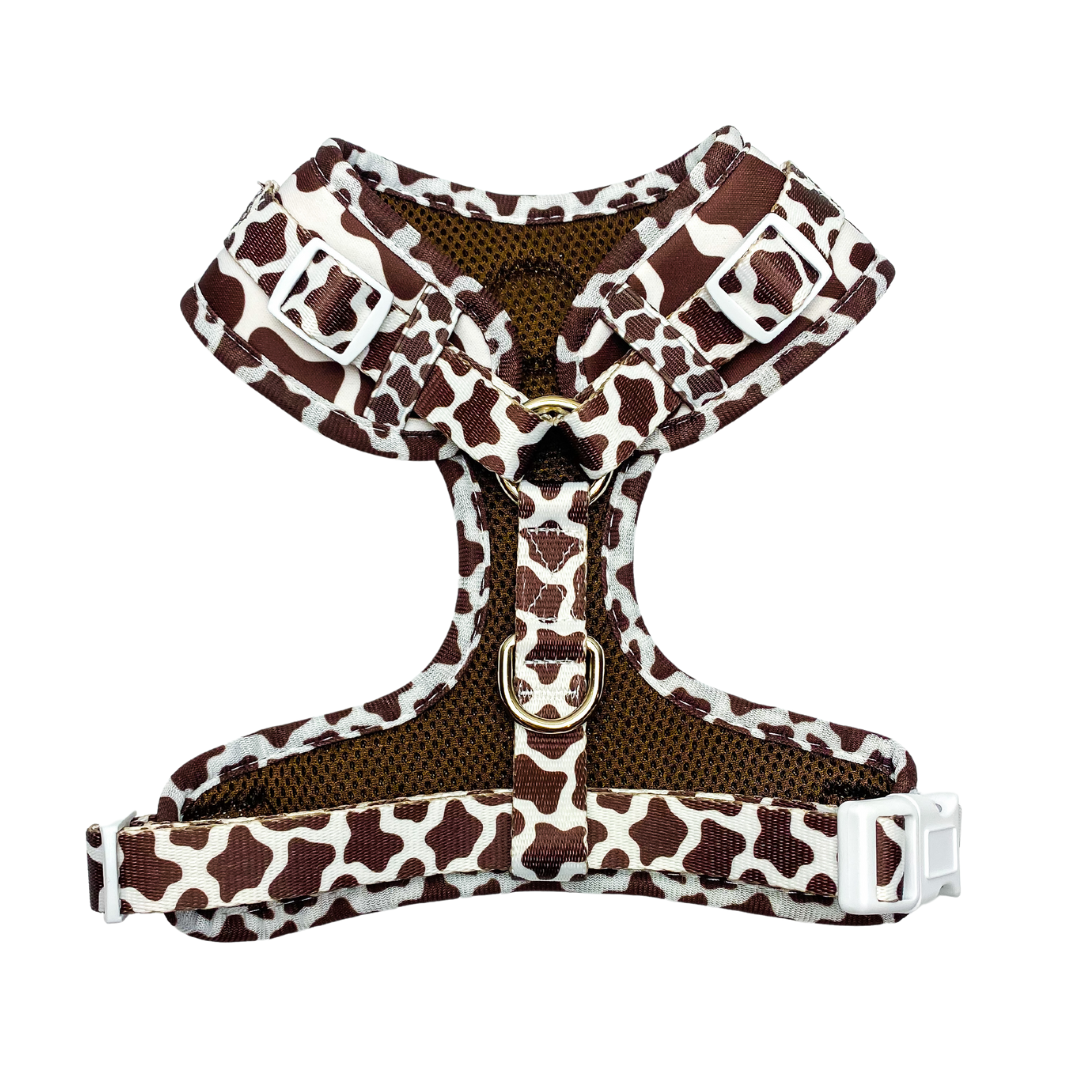 Chocolate Cow Print Adjustable Dog Harness for Daily Walks: Brown/white mesh, gold D-rings, and white buckles.