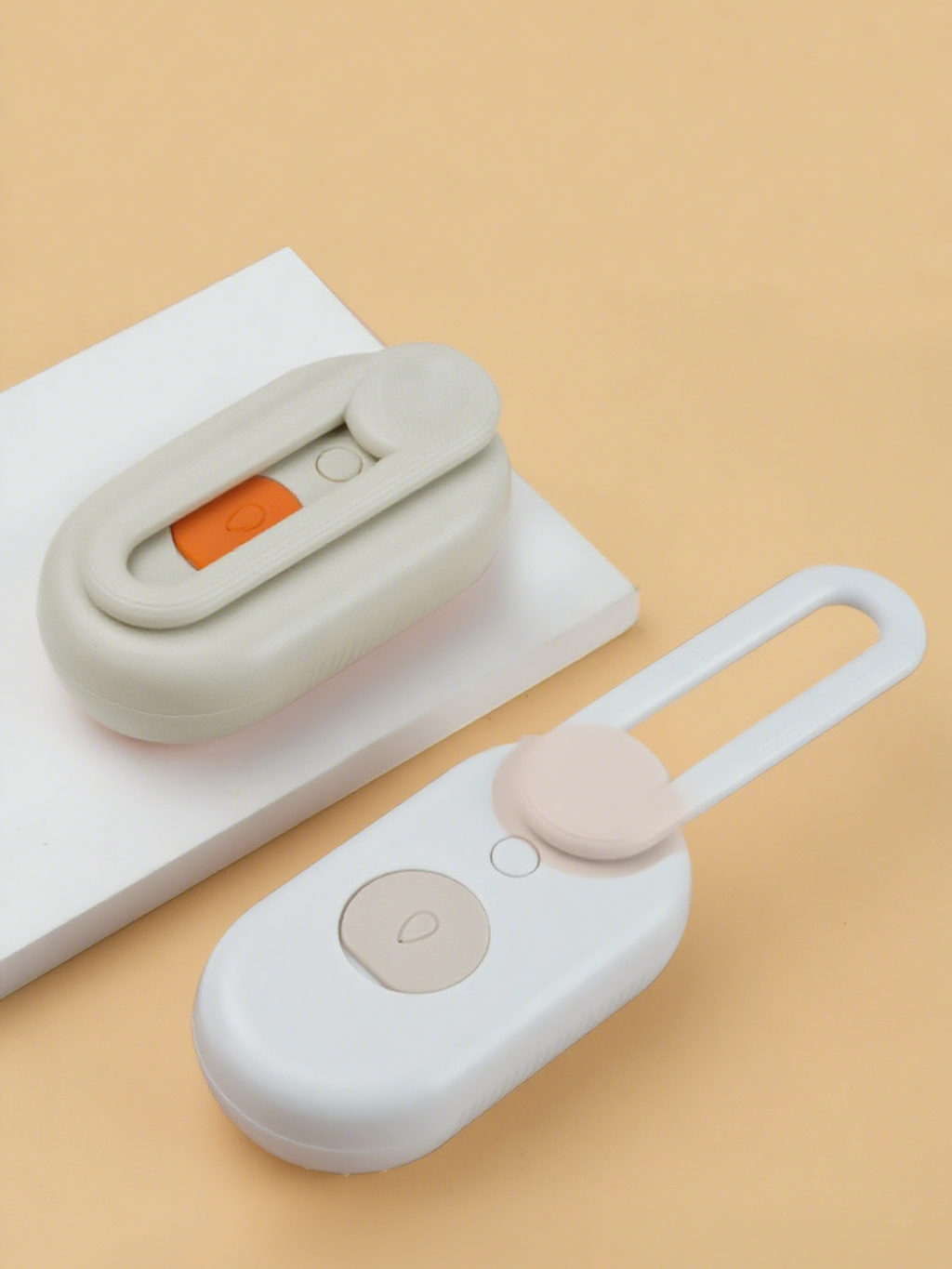 Purrfect Pet Kingdom white and beige steam pet deshedders with ergonomic oval bodies and fold-out loop handles.