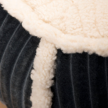 Close-up of charcoal ribbed fabric and cream sherpa lining on the Royal Thrones Bolster pet bed.
