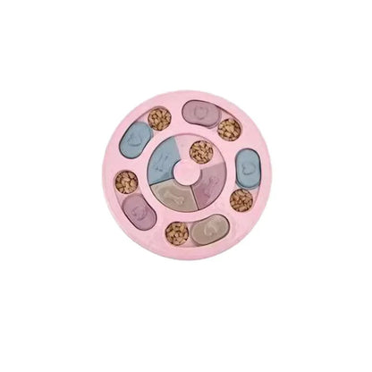 Pink round interactive dog puzzle slow feeder with sliding blue and purple lids and kibble-filled compartments.