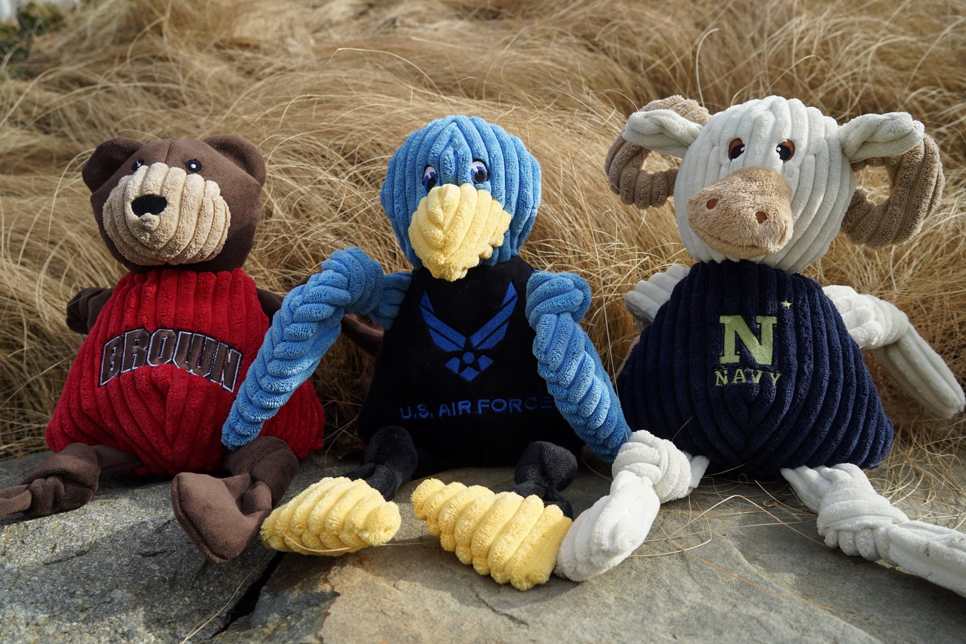 White corduroy Navy Goat dog toy with knotted rope limbs and a navy blue jersey embroidered with "NAVY".