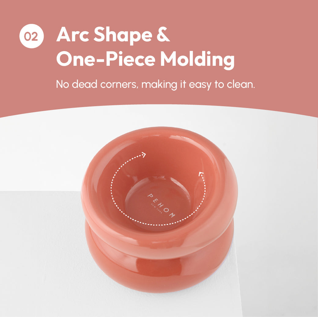 Purrfect Pet Kingdom terracotta ergonomic elevated pet bowl with a glossy arc shape and seamless one-piece molding.