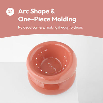 Purrfect Pet Kingdom terracotta ergonomic elevated pet bowl with a glossy arc shape and seamless one-piece molding.