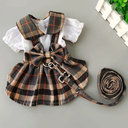 Purrfect Pet Kingdom brown plaid dog dress with white puff sleeves, bow detail, and matching leash.