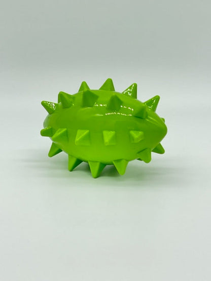 Spikez the Ball: A lime green, football-shaped dog toy with large spikes and a glossy rubber finish.