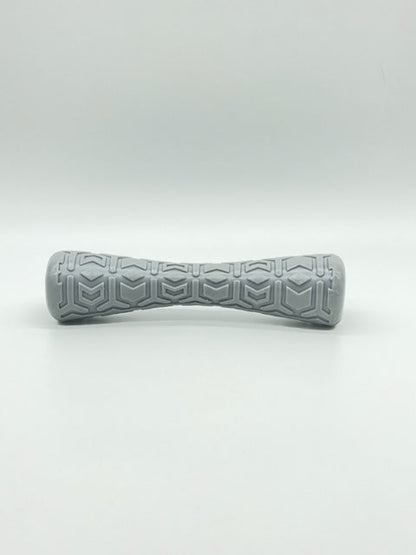 Toys N Treats Box Durable Dog Batton: a light gray textured rubber dog chew toy with a geometric pattern.