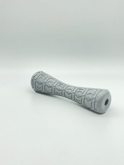 Gray rubber Durable Dog Batton toy by Toys N Treats Box with textured geometric grip and hollow ends.