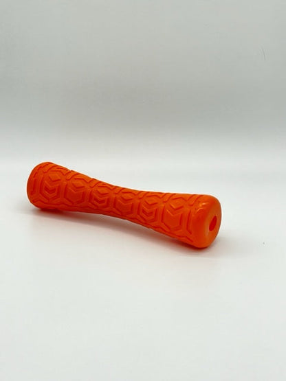 Orange rubber Durable Dog Batton by Toys N Treats Box with a textured geometric pattern and hollow ends.