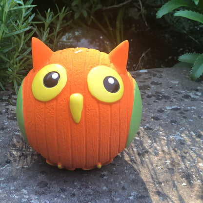 Orange owl-shaped Ruff-Tex textured rubber ball dog toy with green wings and large yellow eyes.
