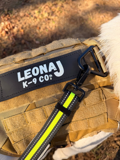 Hands-free neon green and black bungee leash with reflective stitching on a LeonaJ K-9 Co. tactical dog harness.