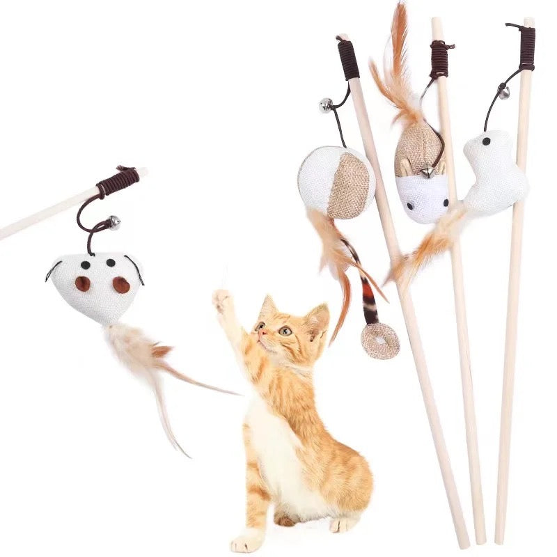 Toys N Treats Box wooden teaser wands with linen toys, feathers, and bells. Ginger kitten playing with mouse wand.