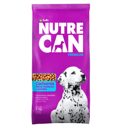 Nutre Can Premium 2kg dry puppy food: purple bag featuring a Dalmatian puppy, white logo, and dry kibble preview.