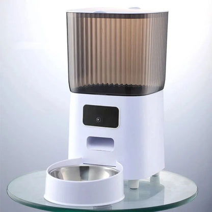 White smart cat feeder with a front camera, smoked ribbed 5L hopper, and stainless steel bowl.