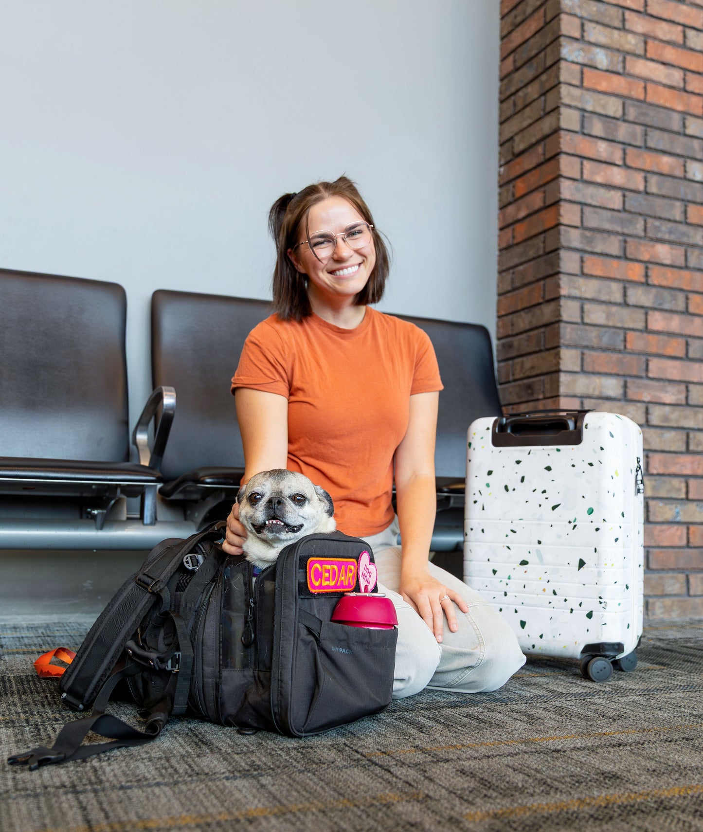 K9 Sport Sack Carrier Backpack with a happy dog peeking out, perfect for travel with your dog backpack