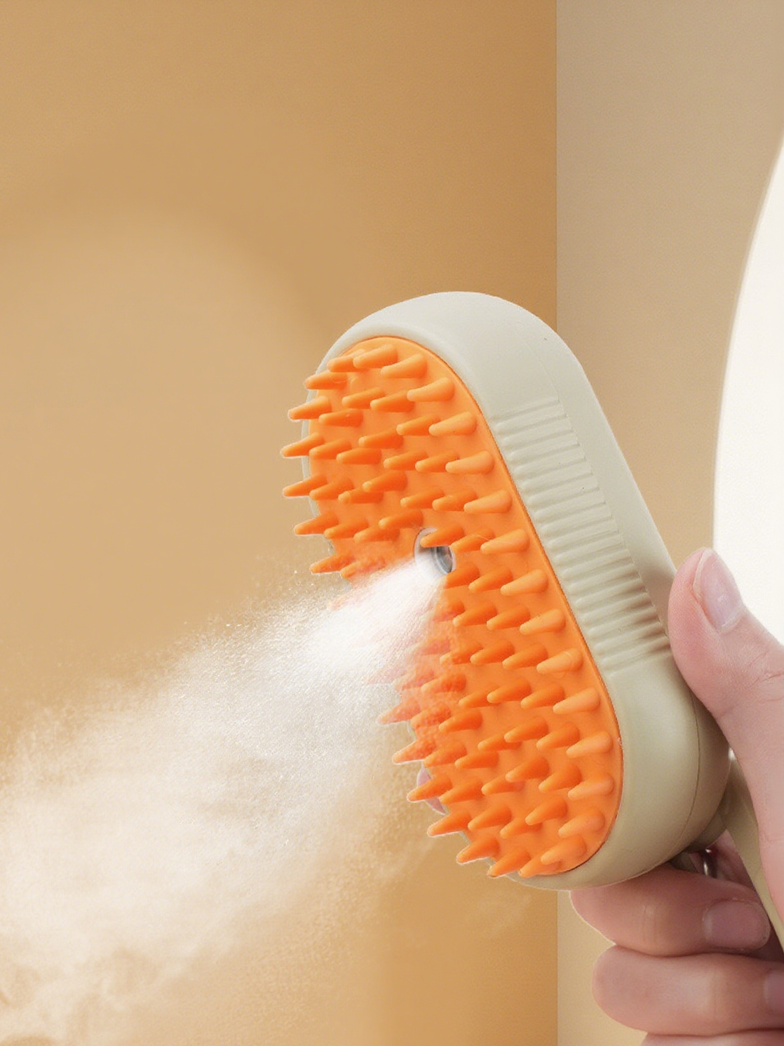 Milou & Lumi 4-in-1 Steam Pet Deshedder: Dr. Milou cream body with orange silicone bristles emitting a fine mist.