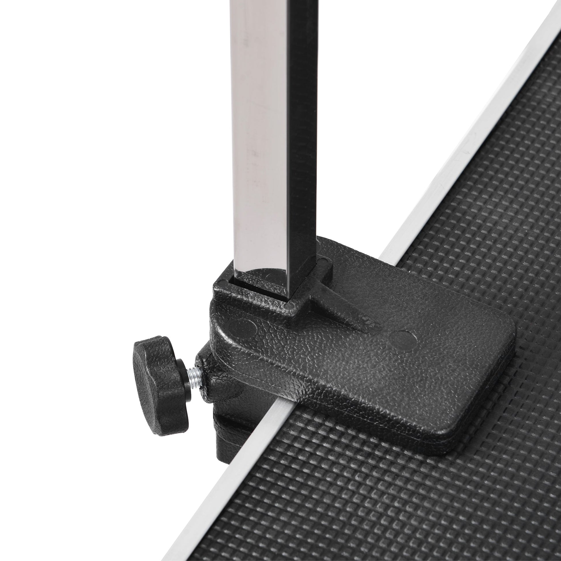 Close-up of an adjustable dog grooming table with sturdy legs and a textured surface for stability