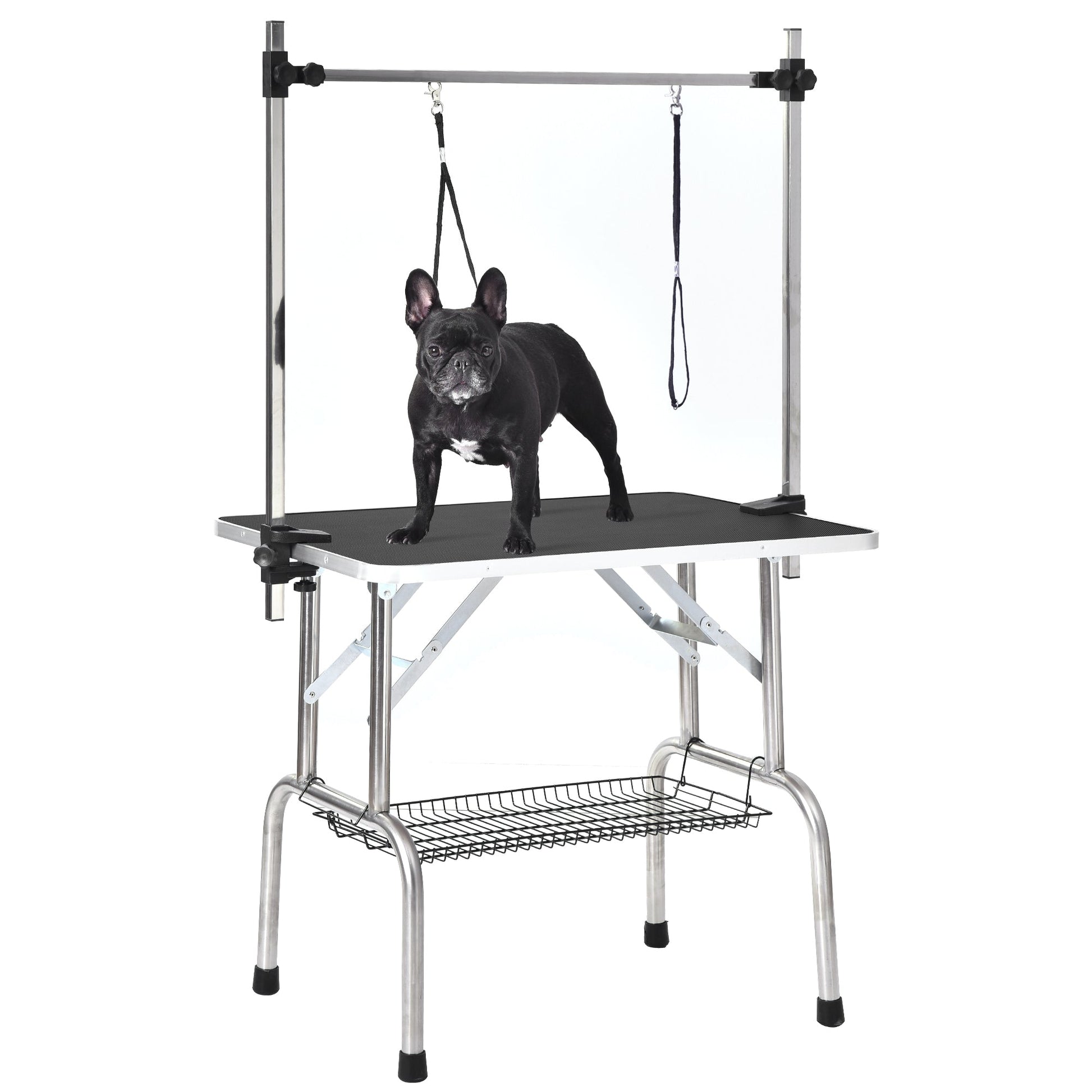 Adjustable dog grooming table with a French Bulldog standing on it, featuring a sturdy frame and storage shelf