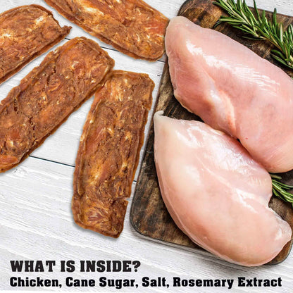 Purrfect Pet Kingdom high-value chicken jerky dog treats next to raw chicken breasts and rosemary on a wooden board
