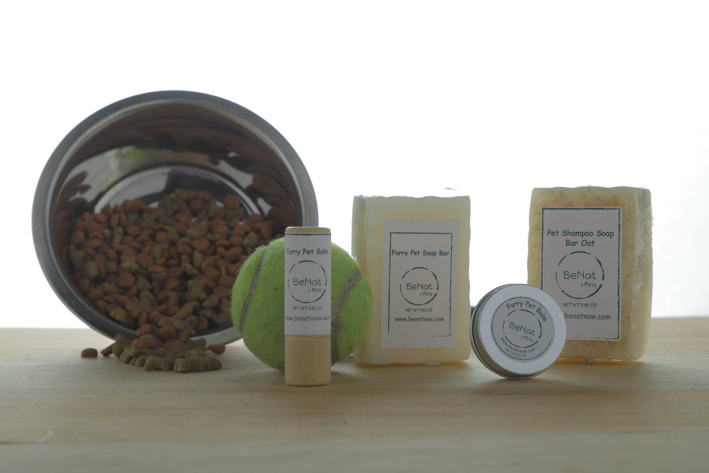 Natural pet grooming products including soap bars, deodorant, and a toy for dogs by WooF WooF MeoW