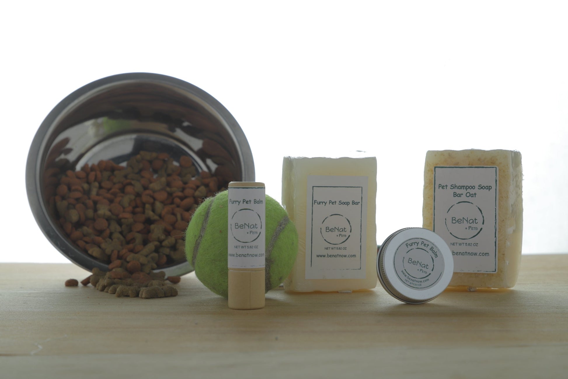 Natural pet grooming products including soap bars, deodorant, and a toy for dogs by WooF WooF MeoW