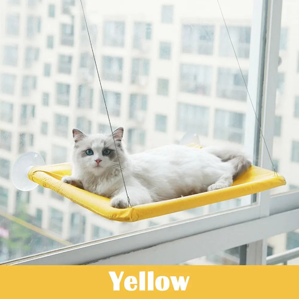 Yellow elevated cat perch by Purrfect Pet Kingdom with a white cat lounging on the best window seat for cats