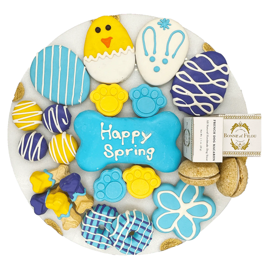 Purrfect Pet Kingdom luxury dog treats decorated in spring designs including bones, paws, and eggs