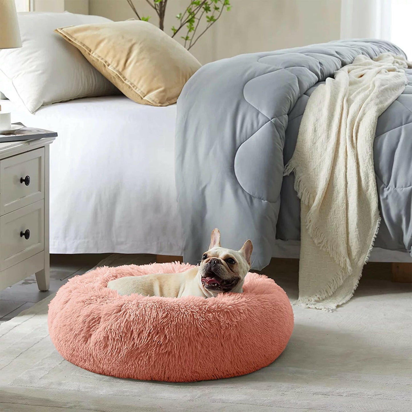 Cozy calming pet bed for anxious dogs in a soft peach color with a relaxing round design