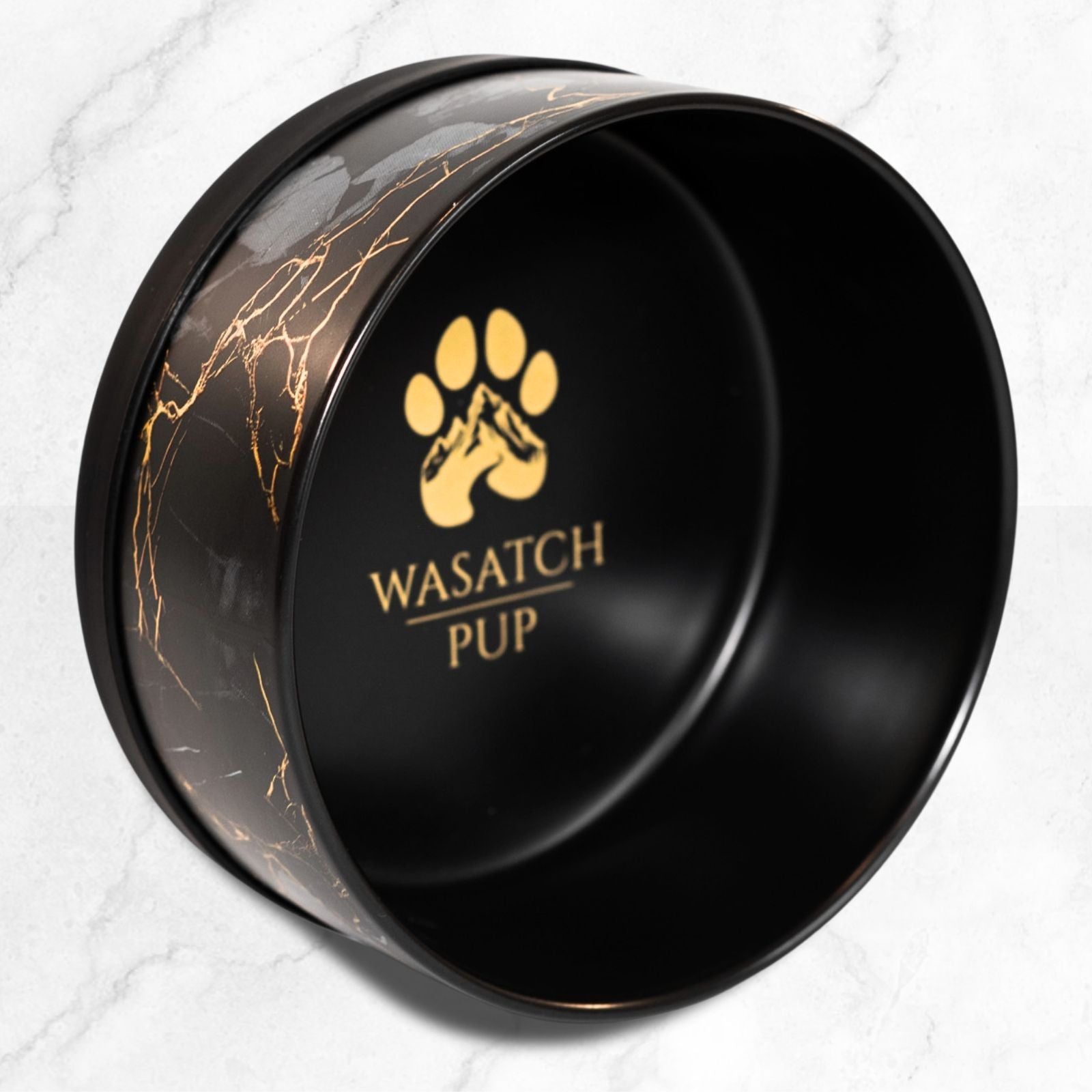 Wasatch Pup black ceramic Artisan Marble Heritage Bowl with gold marble veining and a gold paw logo inside.